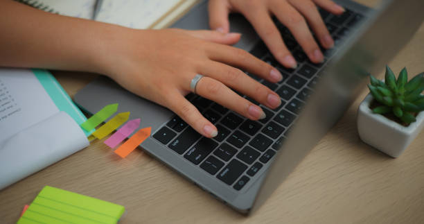 istock Young Asian woman working with a laptop on a desk 1549998332