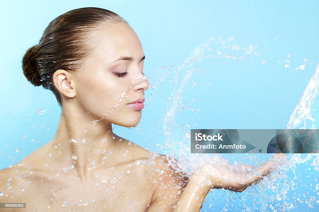 Beautiful girl and stream of water Beautiful girl and stream of water on a blue background Women Stock Photo