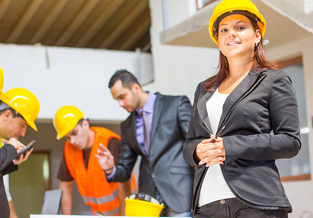 istock Group of architects looking at the blueprints and plans. 155001472