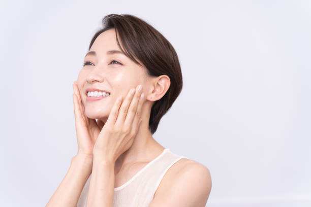 Beauty portrait of middle aged asian woman Skin care. An asian woman with beauty face is  touching healthy facial skin. skin cheek stock pictures, royalty-free photos & images