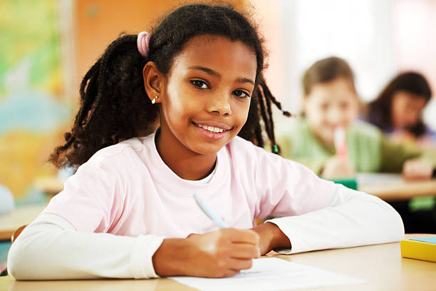 istock Girl writes in notebook at the classroom. 155002603