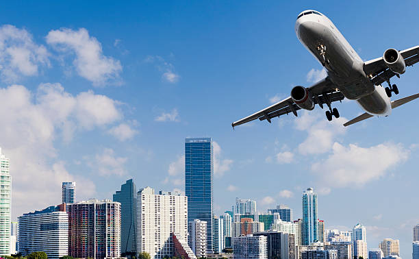 istock Airliner Landing with City Skyline in the Background 155004082