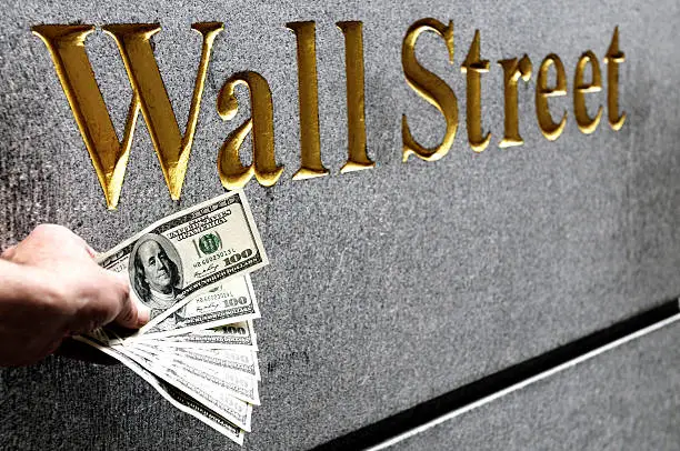 Photo of Hand Holding Money, Wall Street, NYC.