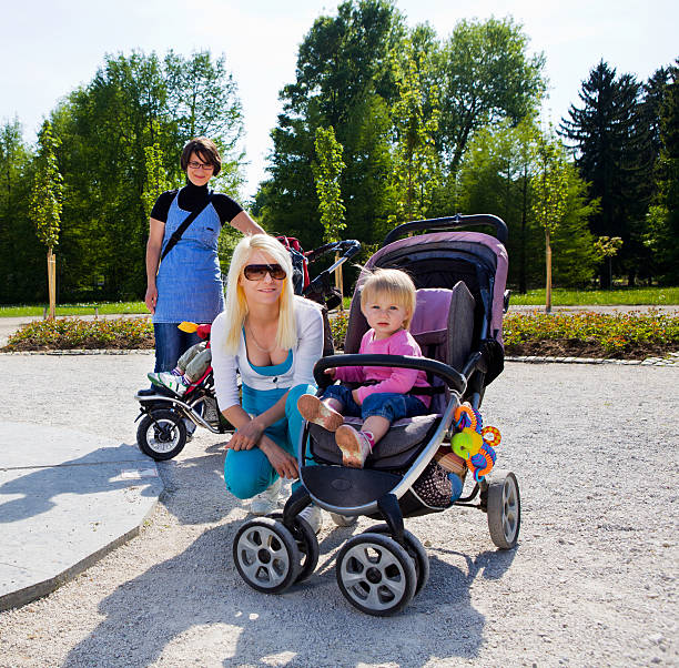Beautiful black mother with her family made up of six children on an autumn walk in the park
