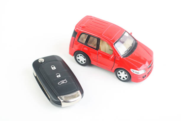 istock Small toy car and Remote control car key 1550049861
