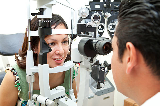 istock Female getting her eyes checked out by eye doctor 155006678