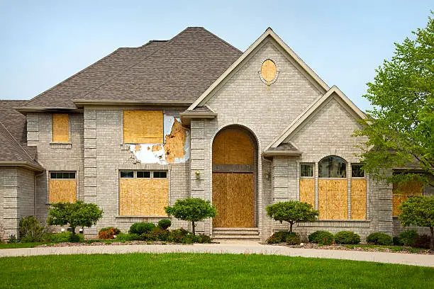 Photo of Destroyed Mansion House With Boarded Windows