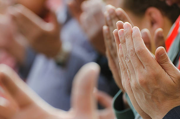 Muslim men praying with lifted hands in Cairo, Egypt