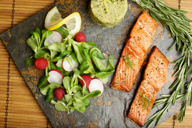 istock Slate tile plated grilled wild Salmon fillet arugula and couscous 155008691