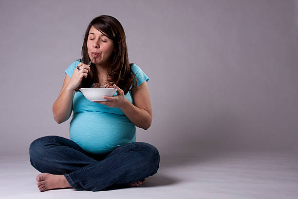 Pregnant Woman Eating Ice Cream stock photo