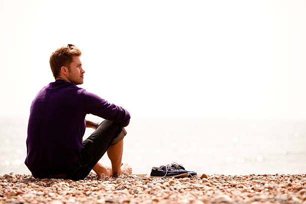 istock Handsome British fellow sitting on the beach in Brighton 155009152