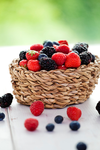 Fresh picked strawberries, blueberries, blackberries and raspberries  in a basket