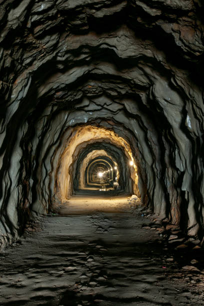 istock Old dark tunnel in the rock. 1550094090
