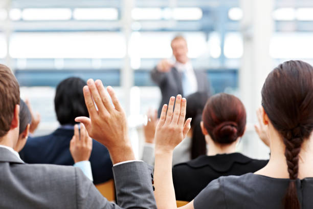 istock Business People Raising Their Hands at a Conference 155009740