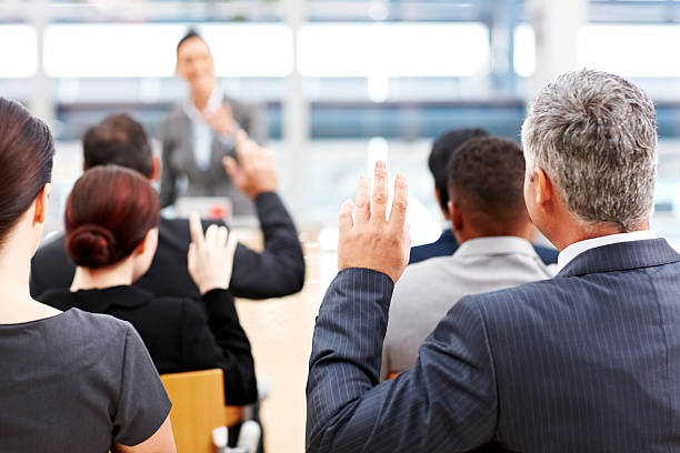 istock Businessman Raising His Hand at a Conference 155009792