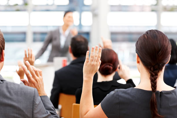istock Business People Raising Their Hands at a Conference 155009811