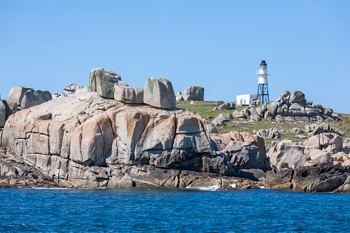 Lighthouse and rocky promontory of Peninnis Head, St. Mary's, Isles of Scilly, UK.  Peninnis Lighthouse was built by Trinity House in 1911 on St. Mary’s Island in the Isles of Scilly