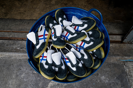 A basket of freshly sewn sneakers outside of a shoe making facility in Bangkok. Daily life in Bangkok, Thailand on July 17, 2023.