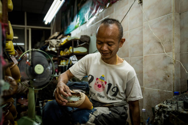 A shoemaker works in Bangkok. Daily life in Bangkok, Thailand on July 17, 2023.