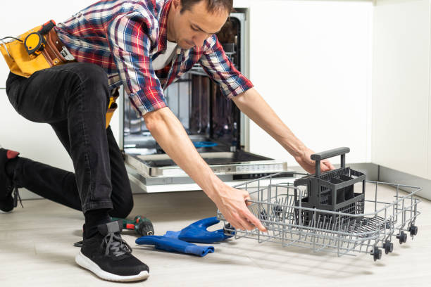 istock Professional worker repairing the dishwasher in the kitchen 1550119341