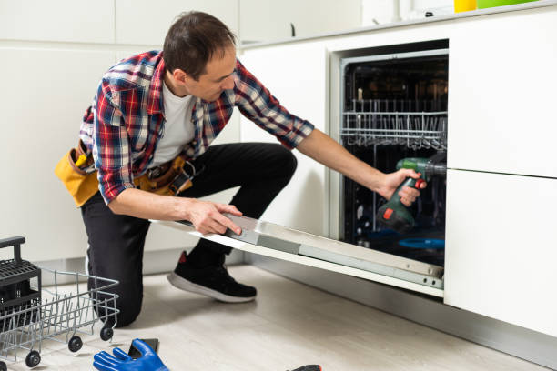 istock Professional worker repairing the dishwasher in the kitchen 1550124625