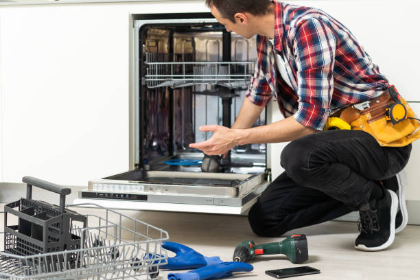 istock Man repairing a dishwasher with tools 1550125684