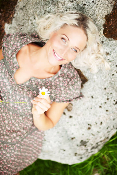 Beautiful young woman on the background of spring flowers