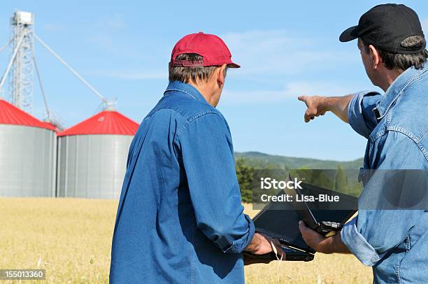 Two Farmers Planning Pc In The Countryside Stock Photo - Download Image Now - Silo, Cereal Plant, Farm