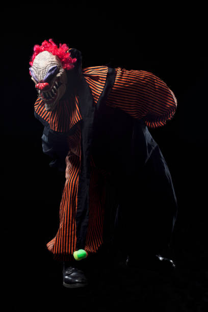 istock Creepy Halloween Clown Costume Portrait on Black, Copy Space 155013611