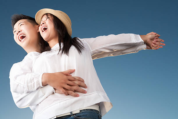 istock Excited asian couple against blue sky 155013710