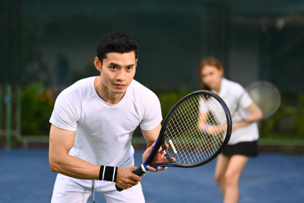 istock Two focused tennis player standing in ready position to receive a serve, practicing for competition on a court. 1550143577