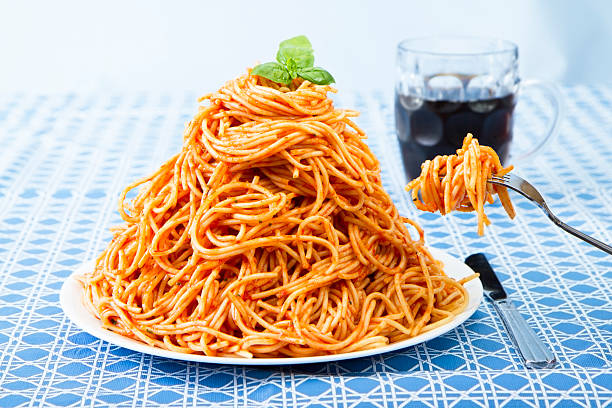 Huge Pile Of Spaghetti On Plate and Twirled Around Fork stock photo