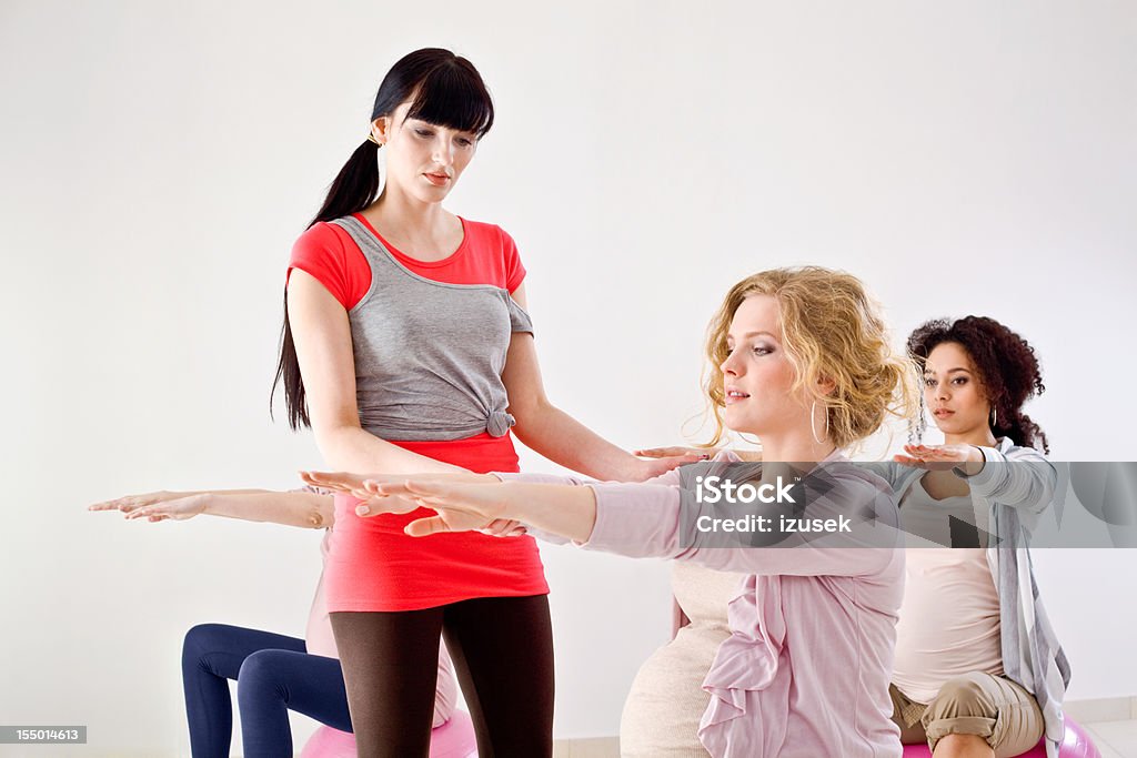 Pregnant women stretching on gym balls  20-24 Years Stock Photo
