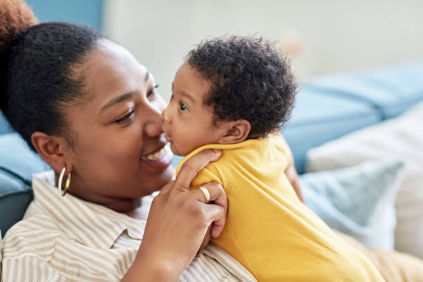 istock Smiling Black mother face to face with baby boy 1550149910