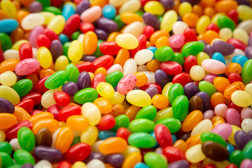 Close up, top view of colorful jelly beans, candy background.