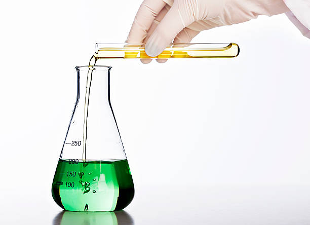 istock Gloved hand mixes chemicals in lab glassware 155016064