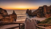 Scenic view of Camilo beach with a set of steps leading down to sandy shoreline at sunrise