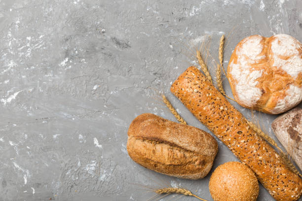 istock Homemade natural breads. Different kinds of fresh bread as background, top view with copy space 1550169244