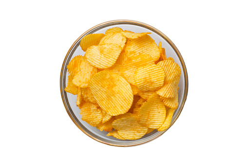Potato chips in glass bowl isolated on white background.