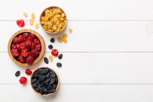 Bowl with different dried fruits on table background, top view. Healthy lifestyle with copy space.