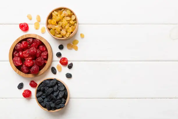 Photo of Bowl with different dried fruits on table background, top view. Healthy lifestyle with copy space