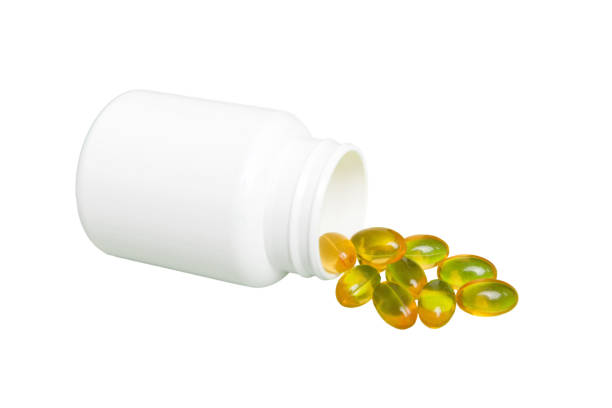 istock White medicines flow from container. medicine white pill bottle isolated on a white background 1550169838
