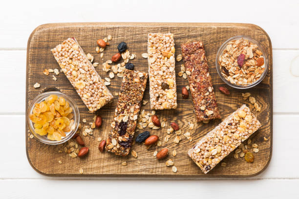 istock Various granola bars on table background. Cereal granola bars. Superfood breakfast bars with oats, nuts and berries, close up. Superfood concept 1550170439