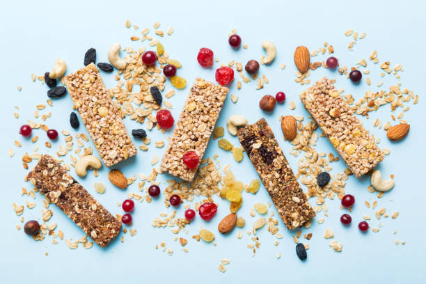 istock Various granola bars on table background. Cereal granola bars. Superfood breakfast bars with oats, nuts and berries, close up. Superfood concept 1550170454