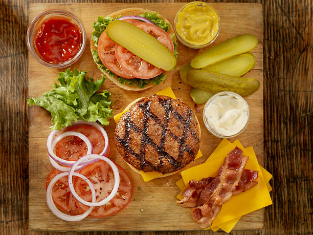 Preparing a Hamburger  bacon cheeseburger stock pictures, royalty-free photos & images