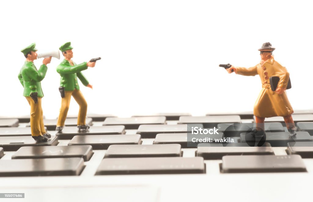 Computer Crime figurines on keyboard abstract  Thief Stock Photo