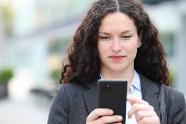 istock Front view of an executive using phone 1550178412