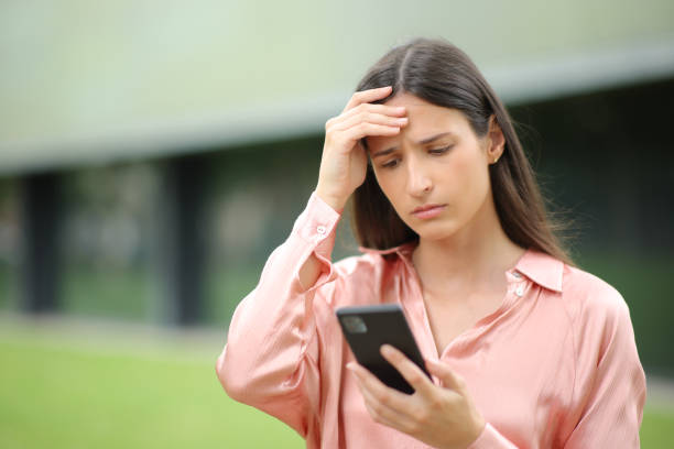 istock Concerned woman checking news on phone 1550178909