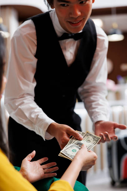 istock Traveler pays Asian concierge for order 1550180679