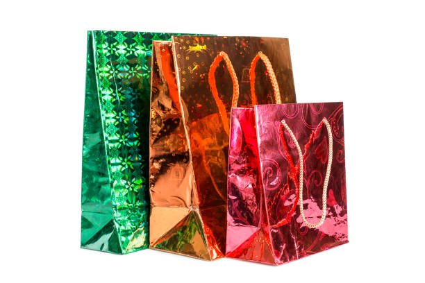 Three holographic paper gift bags isolated on white background